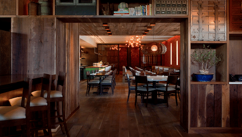 A wide angle view of the dining room and private dining rooms at Uchiko Austin.