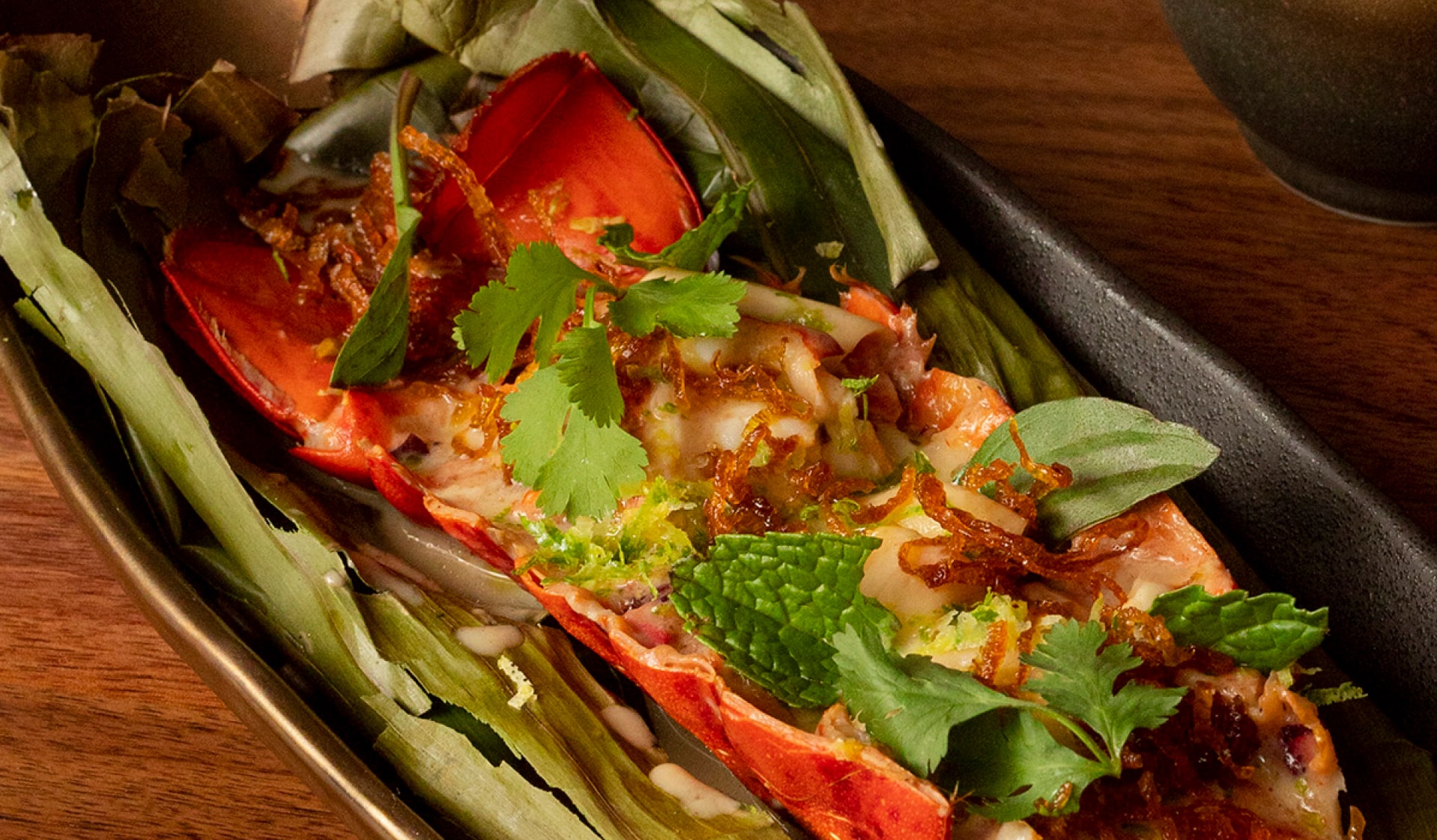 Hearth Roasted Lobster served in a black oval bowl.